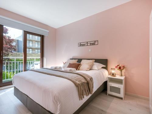 a bedroom with a large bed and a window at Apartment Trondjhem with seaview by Interhome in Bruges