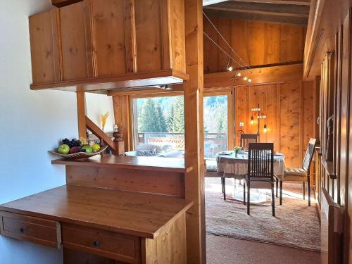 a kitchen with a table and a dining room at Apartment Le Sporting by Interhome in Champex