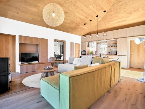 a living room with a couch and a kitchen at Chalet Popcorn by Interhome in Abertamy