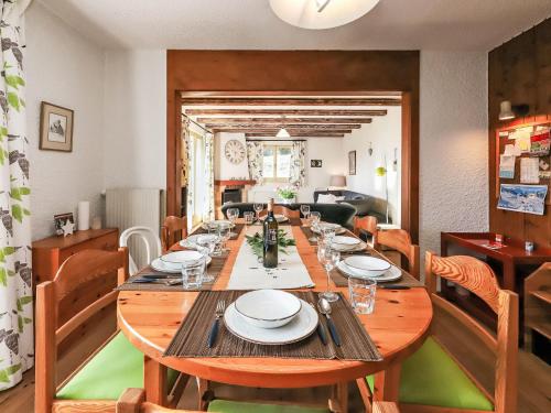 a dining room with a wooden table and chairs at Apartment Regina D1 by Interhome in Arveyes