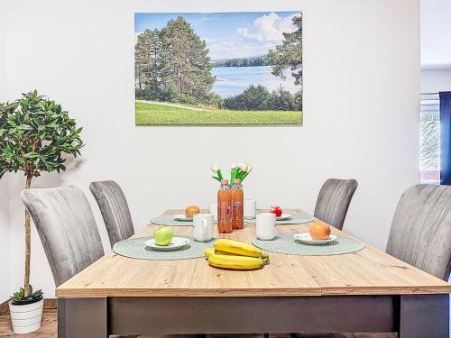 a wooden table with bananas and fruit on it at Apartment Alpenlodge Breitenberg by Interhome in Lechbruck