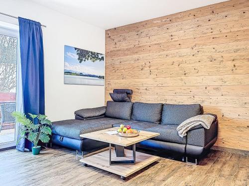 a living room with a couch and a table at Apartment Alpenlodge Breitenberg by Interhome in Lechbruck