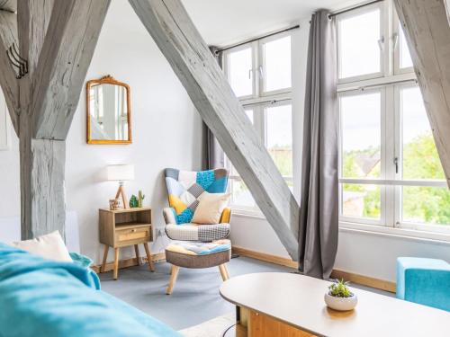 a living room with a couch and a window at Apartment Das königliche Quartier by Interhome in Mirow
