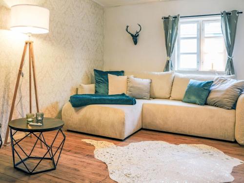 a living room with a couch and a table at Apartment Das königliche Quartier by Interhome in Mirow