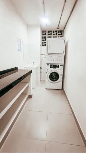 a kitchen with a stove and a washing machine at Torre U kooliving in Manizales
