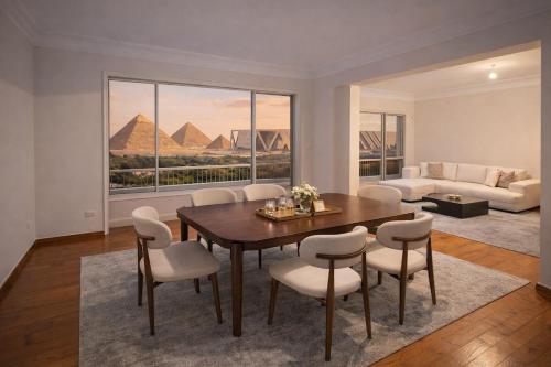 a living room with a table and chairs and pyramids at 3 Pyramids Grand Egyptian Museum View in Cairo