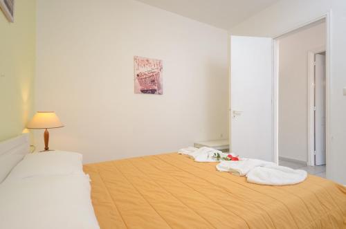a white room with a bed with towels on it at Hotel Francesca in Agios Prokopios