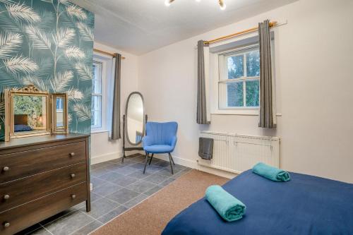 a bedroom with two beds and a dresser and a mirror at 4 Bed in Brecon oc-h30823 in Brecon