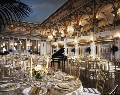 a grand ballroom with a grand piano and tables at Fairmont Copley Plaza in Boston