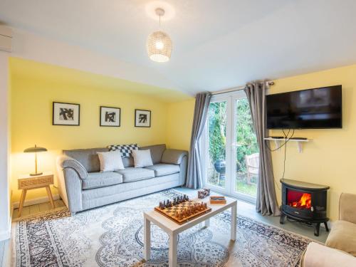 a living room with a couch and a fireplace at Chalet The Chalet by Interhome in Fort Augustus
