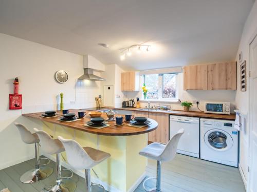 a kitchen with a large island with white appliances at Chalet The Chalet by Interhome in Fort Augustus