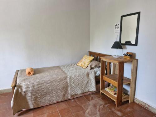 a bedroom with a bed and a table with a mirror at Alojamiento La Liboria, solo mujeres in Córdoba