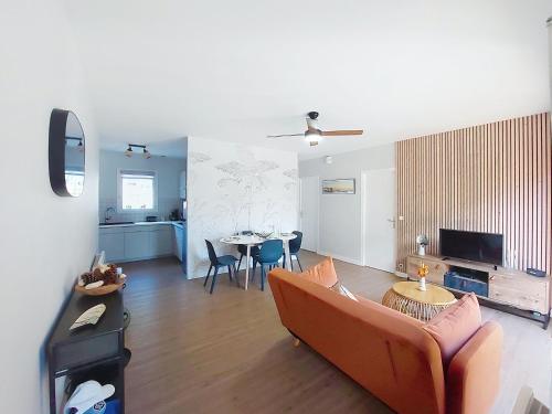 a living room with a couch and a table at Holiday Home Bretons by Interhome in Capbreton