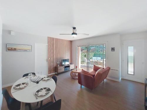 a living room with a table and chairs at Holiday Home Bretons by Interhome in Capbreton
