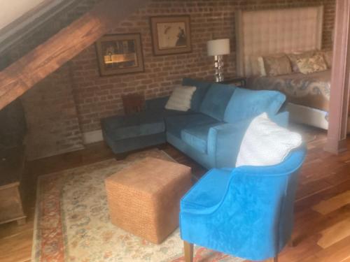 a living room with a blue couch and a bed at NOLA Condos in New Orleans