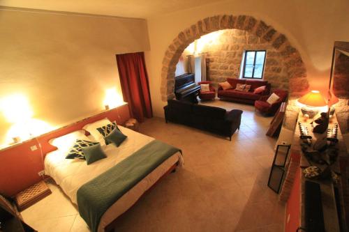 a bedroom with a bed and a living room at Casa Una Storia in Sartène