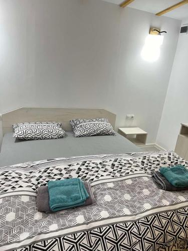 a large bed with two pillows on top of it at Бунгала ЛАГО in Gabrene