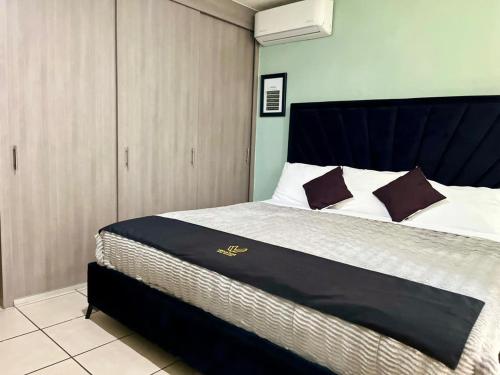 a bedroom with a large bed with a blue headboard at 1 VENATOR House Boutique in León