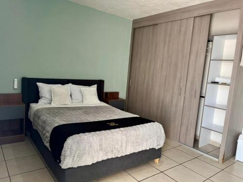 a bedroom with a large bed and a closet at 2 VENATOR House Boutique in León