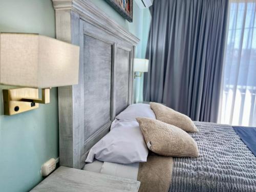 a bedroom with a bed with pillows on it at 5 VENATOR House Boutique in León