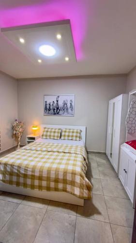 a bedroom with a bed with a yellow and white blanket at 2 bedrooms apartment no 18 in Amman