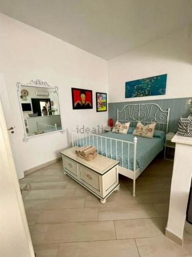 a small room with a bed and a mirror at Donna Sicilia Ortigia in Syracuse