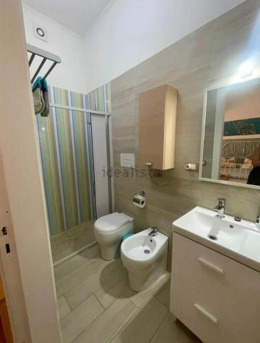 a bathroom with a toilet and a bidet and a sink at Donna Sicilia Ortigia in Syracuse