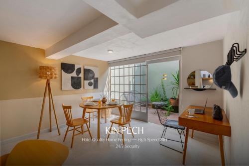 a living room with a dining room table and chairs at Kin Pech Roma by Capitalia in Mexico City