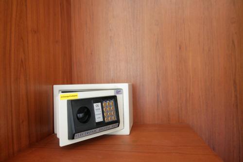 a microwave oven sitting on top of a wooden wall at Calypso Patong Hotel in Patong Beach