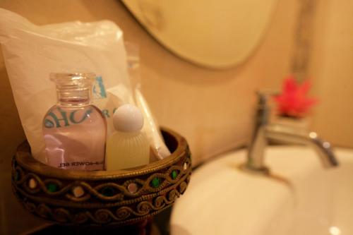 a bathroom with a bottle of soap and toothpaste at Calypso Patong Hotel in Patong Beach