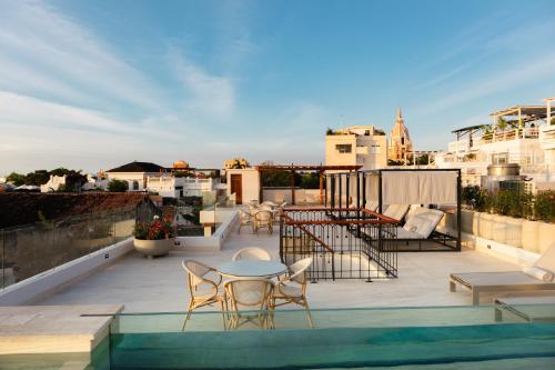 a patio with a table and chairs on a roof at Hotel Palacio del Agua by Faranda Boutique in Cartagena de Indias