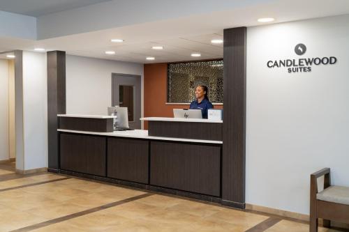 a woman standing at a counter in a dental office at Candlewood Suites Gonzales - Baton Rouge Area by IHG in Gonzales