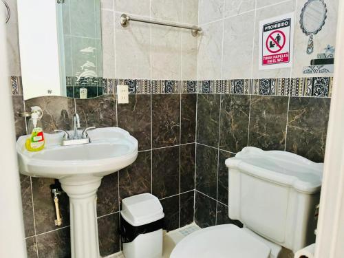 a bathroom with a sink and a toilet at 12 VENATOR House Boutique in León