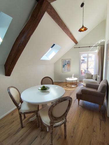 a living room with a table and chairs at Zogbi Hospitality Aubonne 3 in Aubonne