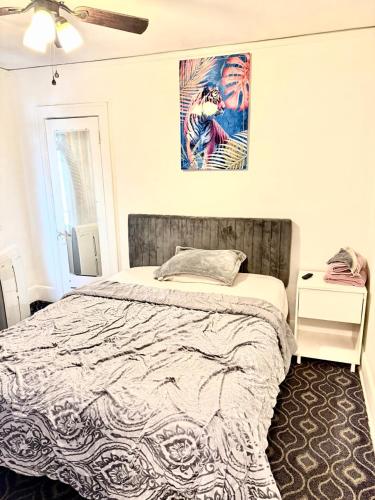 a bedroom with a bed and a painting on the wall at A cozy home with fire place in Detroit