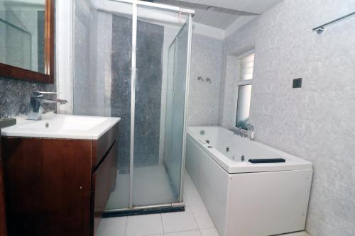 a bathroom with a shower and a toilet and a sink at Pepa's villa and homestay in Khadkagaon