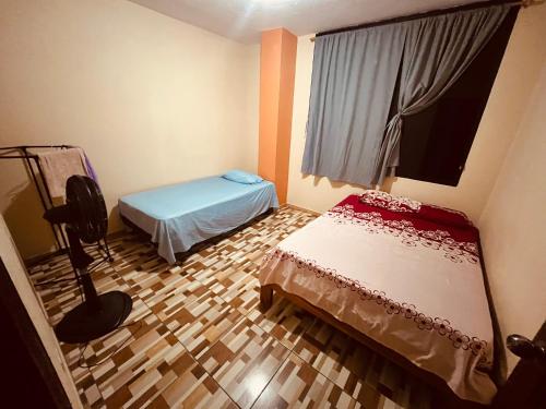 a small room with a bed and a window at Apt 1 in Tena