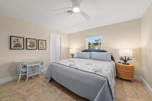 a bedroom with a large bed and a table at Tahitian Waters in Sanibel