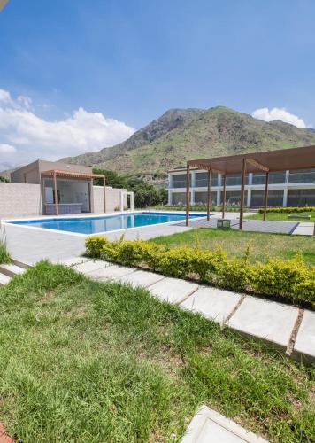an image of a house with a swimming pool at Centro Recreacional Simbal in Trujillo