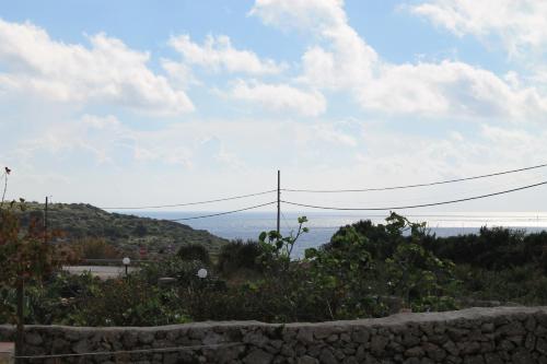 a stone wall with a view of the ocean at Case Canino in Favignana