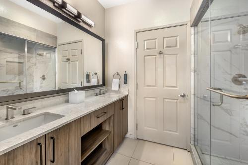a bathroom with a sink and a glass shower at Bluegreen Vacations Club 36, an Ascend Collection Resort in Las Vegas