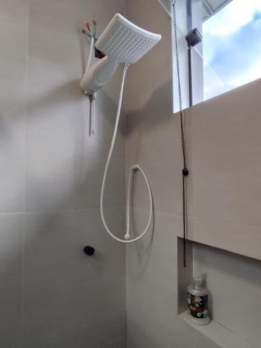 a shower in a bathroom with a shower head at Studio com Ar condicionado, Boa Localização, Internet Rápida 2 in Joinville