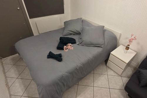 a bed with two black bow ties on it at Studio 33 m2 a saint Michel de Maurienne in Saint-Michel-de-Maurienne