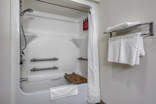 a bathroom with a shower and a bath tub at SureStay Hotel by Best Western Leesville in Leesville