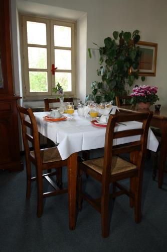 a dining room table with a white table cloth on it at Hotel Calzaiolo in San Casciano in Val di Pesa