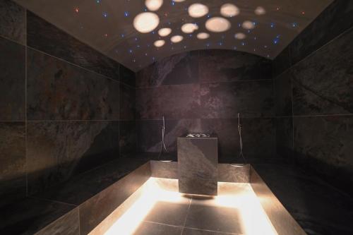 a dark room with a table and a ceiling with lights at Albergo Sporting in Peio Fonti