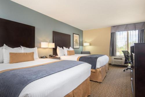 a hotel room with two beds and a window at Wyndham Garden Texarkana in Texarkana - Texas