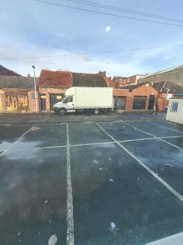 a white truck parked in a parking lot at Lanayr Hotel Blackpool Limited in Blackpool