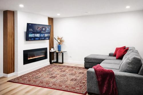 a living room with a couch and a fireplace at 1 BR suite near WEM, with fast WiFi and Equipped kitchen in Edmonton