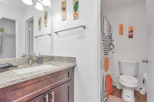 a bathroom with a sink and a toilet at Spacious-2BR2BA- King Ensuite- PVT Patio in Houston